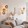 Modern vägglampa Gastor i 2-pack med tre runda glasskärmar i rökfärg och amberfärg