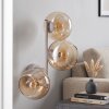 Modern vägglampa Koyoto med tre runda amberfärgade glasskärmar i vertikal rad