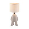Leuchten Direkt bordslampa TED med stiliserad figurfot och beige skärm